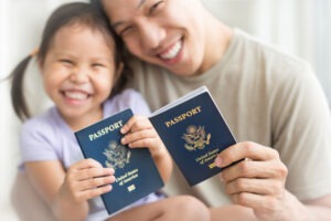 asian-dad-and-daughter-holding-american-passports