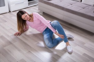 woman falling on hardwood floor