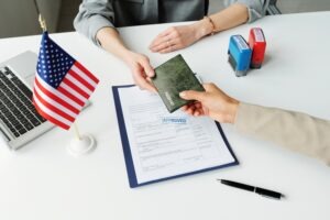 Giving passport to a foreign worker. Evans immigration lawyer can help you with your immigration case.