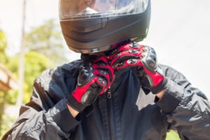 Man in a Motorcycle with helmet and gloves. What to do after a motorcycle accident