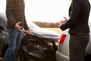 Two drivers arguing after an accident, one of the reasons why you need a car accident lawyer.